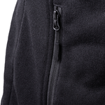 Close-up of a black fleece jacket with zipper detail on a white background