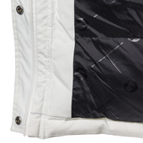 Close-up of a white jacket with black lining and buttons.
